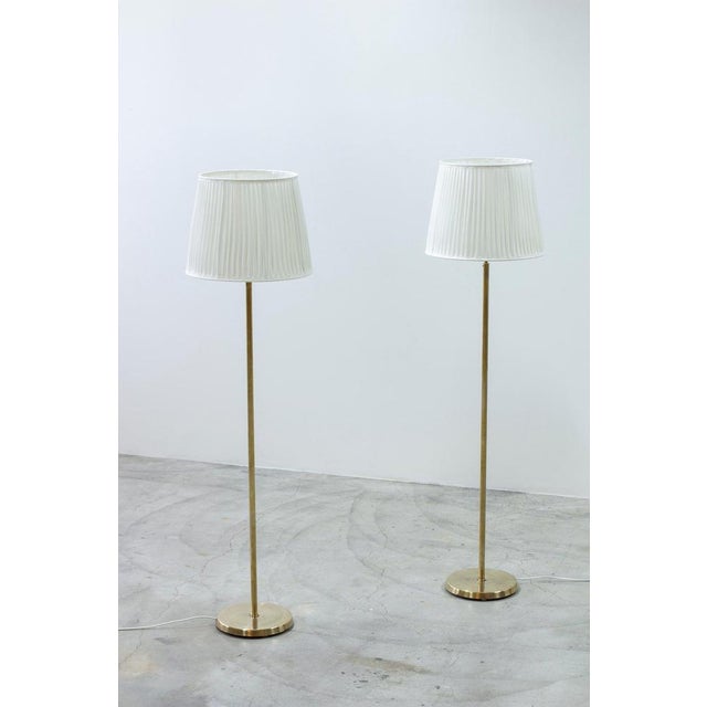 Pair of floor lamp produced in sweden by asea belysning. Made during the 1950s. Polished brass and new lamp shades with...