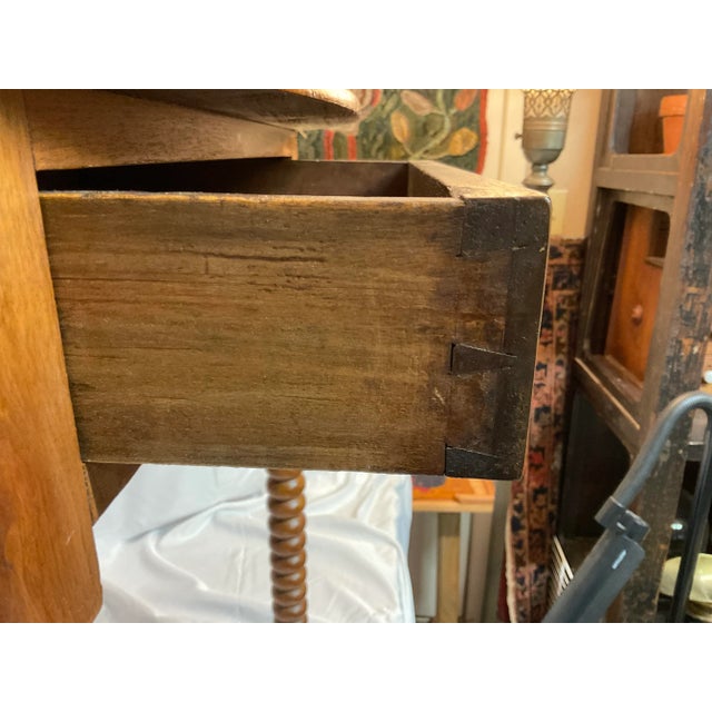 Four expertly turned legs support this fabulous walnut writing table that was made in the late 19th Century. The table’s...