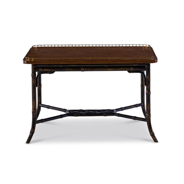 Evoking the spirit of classic campaign furniture, this rectangular table features a rich wood top framed with a delicate...