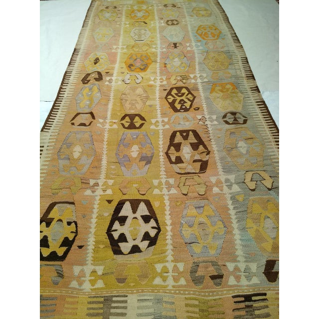 Handwoven in Eastern Anatolia in the first quarter of the 20th century, this room-size vintage kilim is a showcase of...
