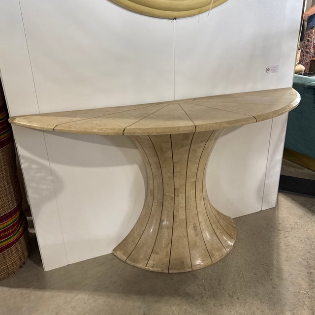 A vintage tessellated marble and brass demi lune table. The table is inlaid with brass strips and has a nice, old patina....
