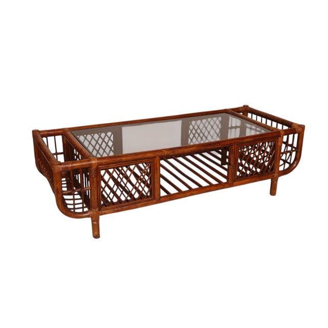 A mid-century modern glass top bamboo coffee table. Stained a rich mahogany color, thick bamboo pieces form the frame with...
