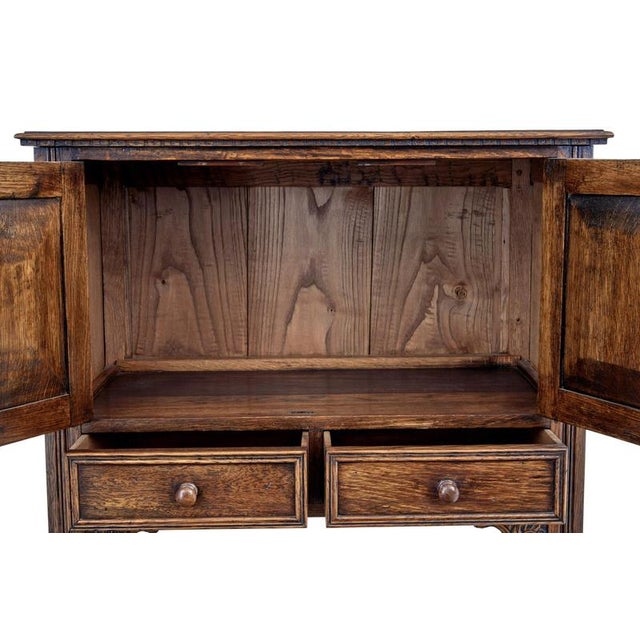 Carved oak Gothic Revival cupboard, circa 1980 Here we have an Ipswich-made piece of furniture from England, crafted in...