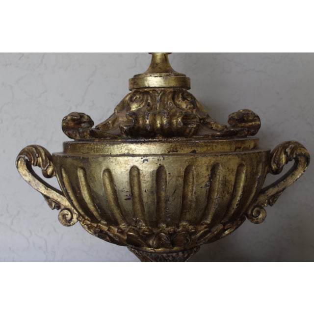 Beautiful antique Italian giltwood table lamp in an elegant neoclassical urn form. This striking piece features a carved...