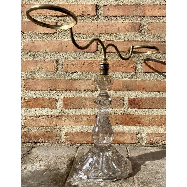 A rare French cut glass and brass candlestick.This stunning mid-century candlestick is made of cut glass with 2 brass arms...