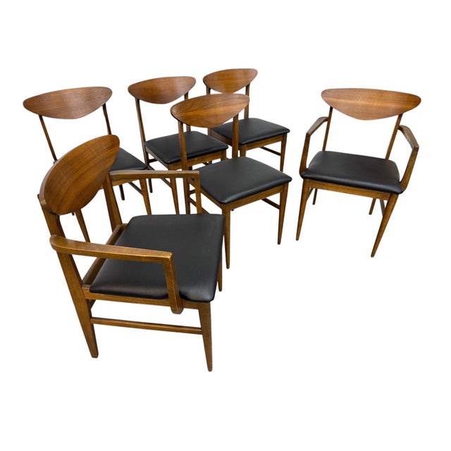 Elevate your dining space with this stunning set of six Mid-Century Modern walnut dining chairs. Featuring sleek sculpted...
