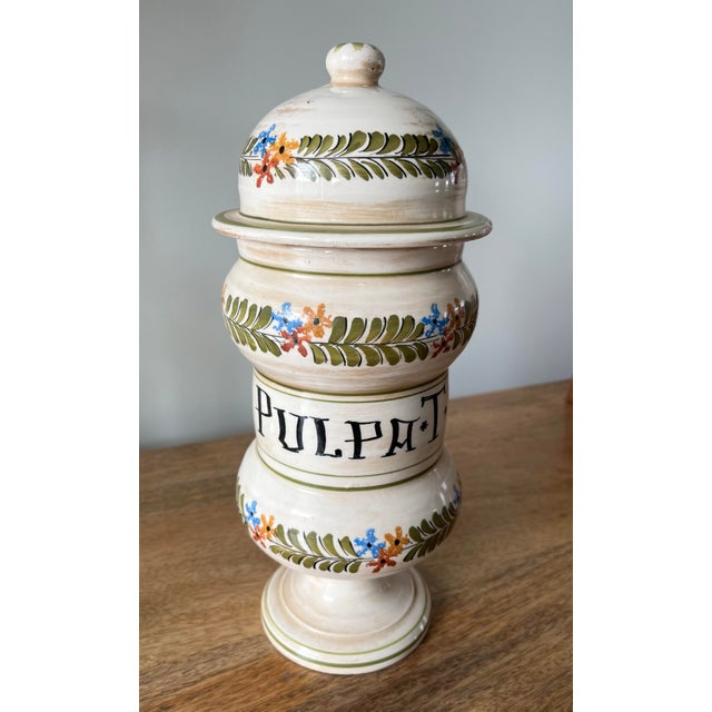 Accent your home with this gorgeous Italian faience vessel. Hand-painted botanical motifs encircle the body and lid of...