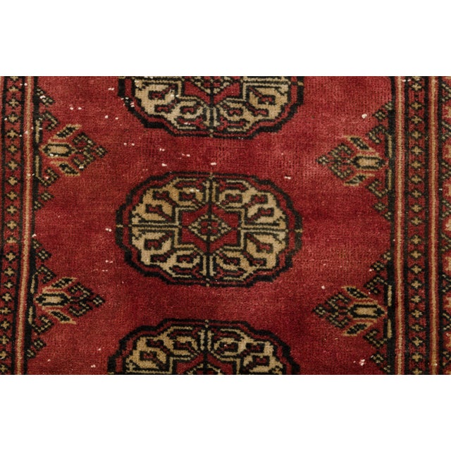 This is a vintage Turkish Oushak rug from the Mid 20th Century. The piece was hand-knotted.