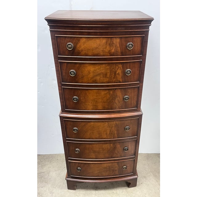 This item is a Bevan Funnell flamed mahogany serpentine-fronted tallboy lingerie chest of drawers, handmade in England....