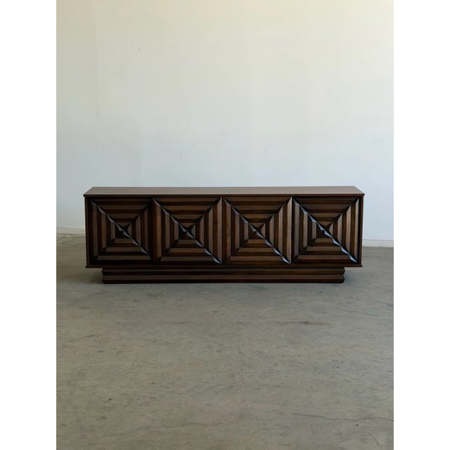 W88 D19.25 H29.5 A striking vintage credenza featuring bold geometric door fronts and classic Brutalist-inspired design....
