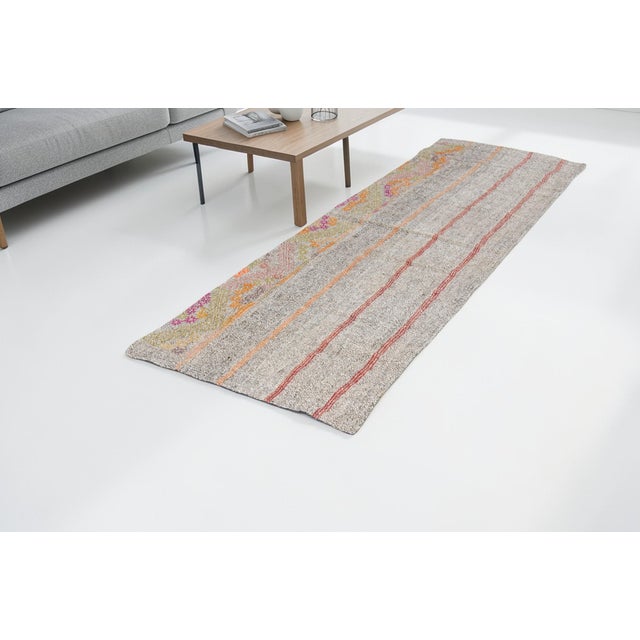 This is a vintage Turkish Oushak rug from the Mid 20th Century. The piece was hand-knotted.