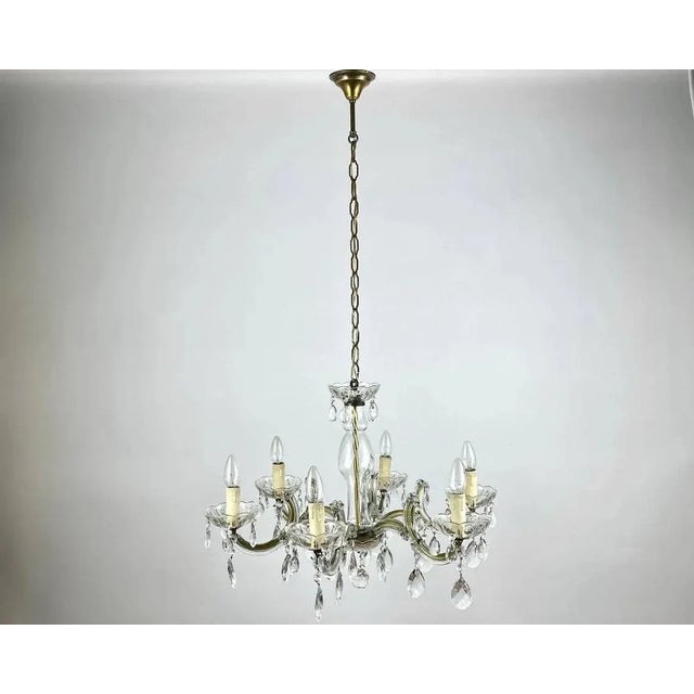 Vintage Maria Theresa style Chandelier with six brass arms on wich faux candles installed. Germany. The framework is in...