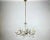 Vintage Maria Theresa style Chandelier with six brass arms on wich faux candles installed. Germany. The framework is in...