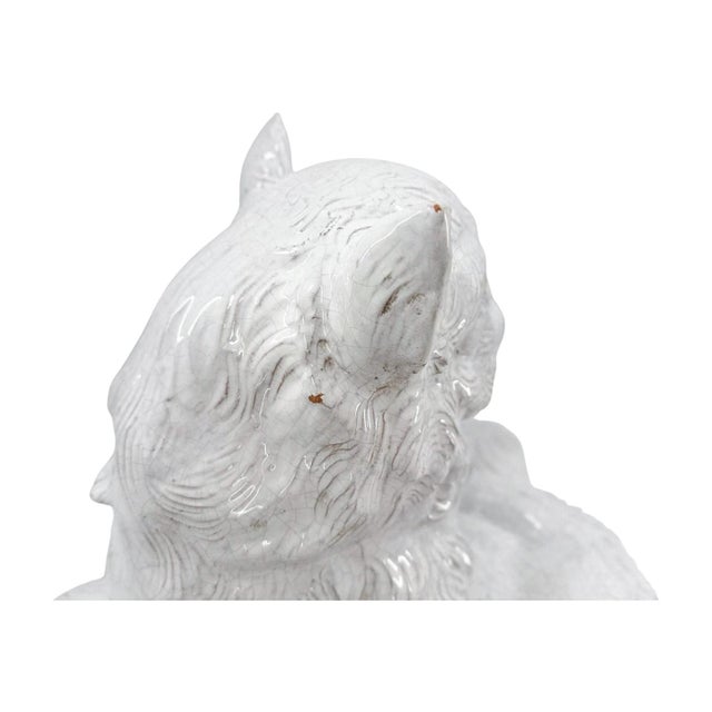 A charming mid-20th century Italian ceramic sculpture by Ceccarelli, depicting two cats resting together atop a tasseled...