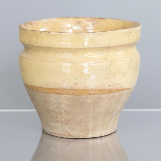 A hand thrown rustic glazed confit pot that has come from a home in France. It dates from the 19th century and shows its...
