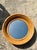 This striking mirror features a series of thick, concentric rings of hand-formed bent rattan that create a deep,...