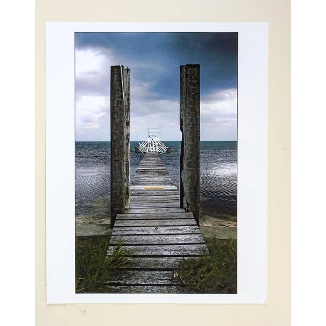 Gray sky and pier with white gate photograph. Unsigned. Unframed.