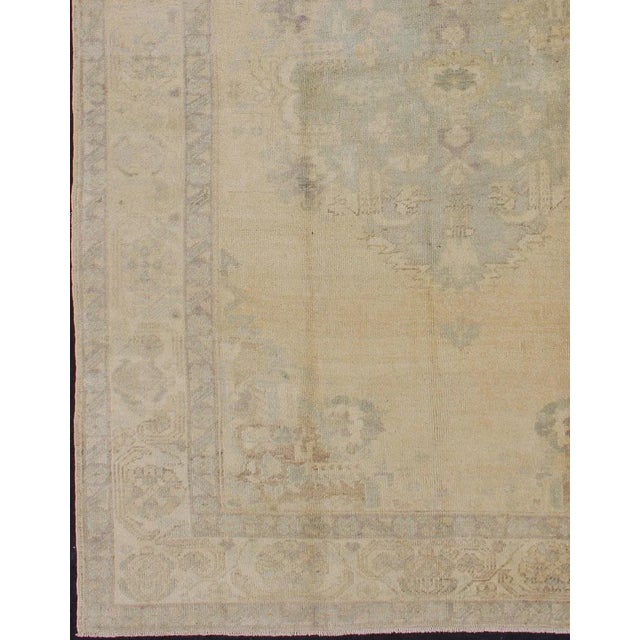 Turkish Oushak Vintage Turkish Rug With Faded Central Medallion Design in Cream Colors For Sale - Image 3 of 13