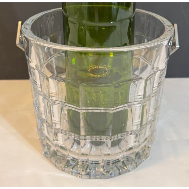 Vintage crystal window pane pattern ice bucket made in Slovenia. Very thick heavy crystal that catches the light nicely....