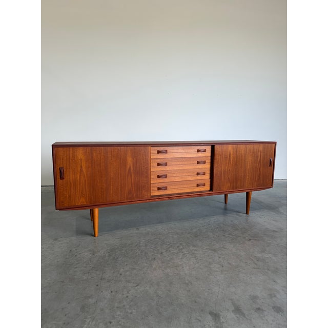 Long Danish Teak credenza or sideboard by Clausen & Son Denmark c.1960’s. Large sliding door at either end open to ample...
