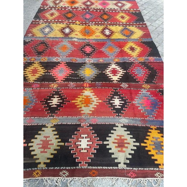 Nice vintage Caucasian Kilim with a beautiful geometrical and tribal design and nice colours with a purple and pink Blue,...