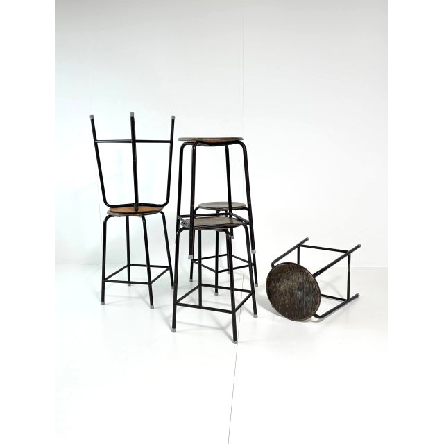 Characterful vintage bar stools from the German manufacturer SCHMITZ, featuring black lacquered tubular steel frames and...