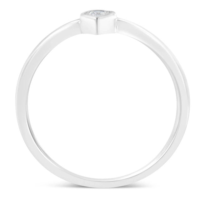 A diamond and sterling silver ring. The ring features a central round diamond miracle set to resemble a pear shape, which...