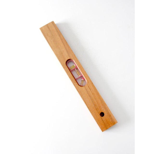 This vintage Sears Roebuck and Co. carpenter's level features a solid hardwood body with three bubble vials set in a...