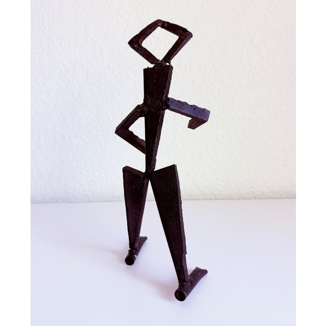 Brutalist style wrought iron figurative sculpture of a walking man. Unsigned.