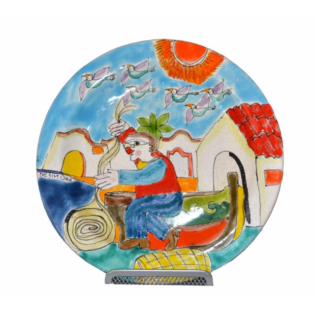 Original Italian Giovanni DeSimone hand painted art pottery, round decor plate depicts a scene of a fisherman folding his...