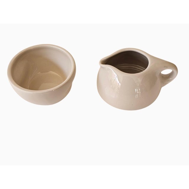 Russel Wright Oneida MCM style linen white stoneware stacking creamer and sugar set. The creamer sits on top of the sugar...