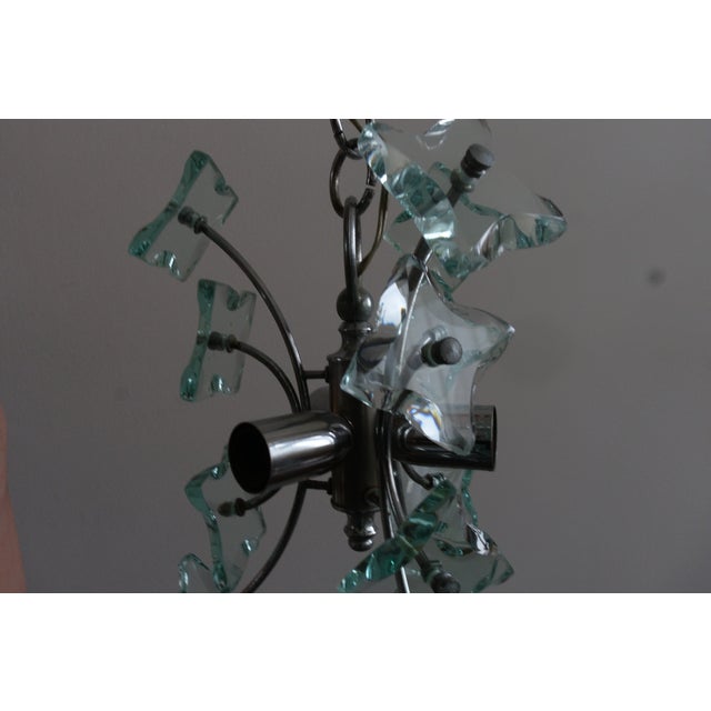 Chrome frame with twelve cut glass elements in aqua. Fontana Arte’s Sputnik series exemplifies Italian mid-century...