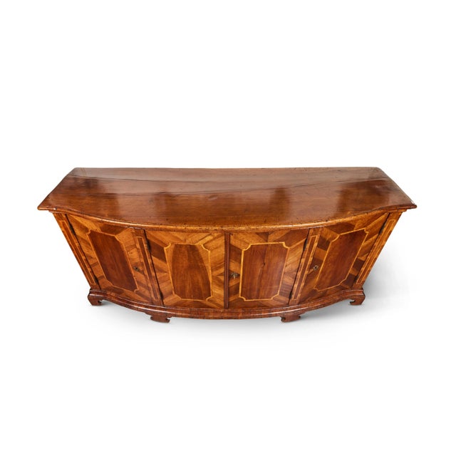 Striking, large, hand-carved, walnut and pearwood inlaid and veneered, four door, bow front buffet from Tuscany. The faux...