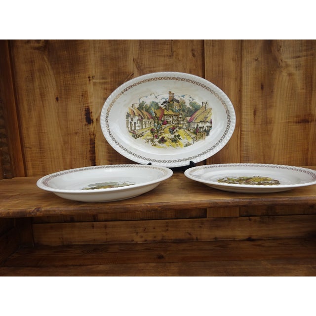 Three matching platters in different sizes and with coordinating designs. One oval platter (37 x 26 cm), one round,...