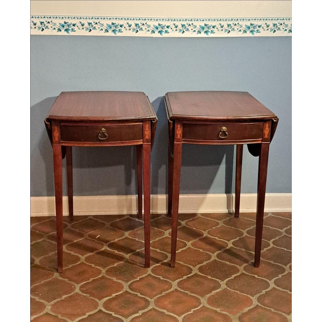 Elegant pair of Hickory Chair style drop leaf side tables featuring a rich dark red-toned finish and decorative fan inlay...
