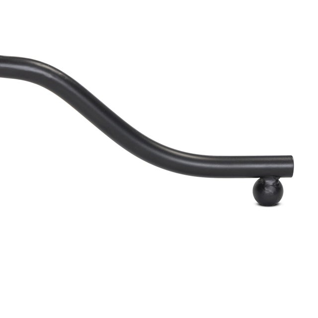 A dark brass base contrasts a smooth taupe marble top with heavy veining for added movement.