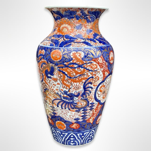 A very large 19th-Century Japanese Arita Imari porcelain vase with baluster body and flared neck. It is hand painted in...