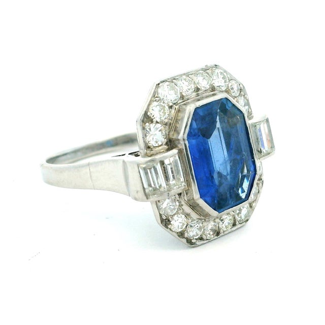 Striking and refined, this platinum ring centers a richly colored natural Sri Lankan sapphire weighing approximately 2.5...