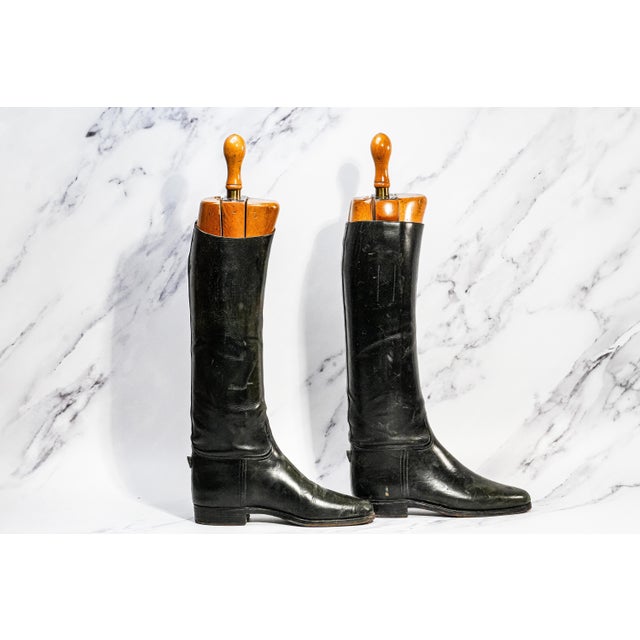 A striking pair of authentic 1930s Peal & Co. English black leather riding boots, these timeless classics embody the quiet...