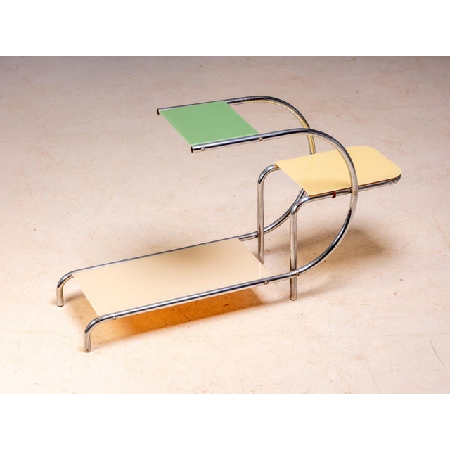An elegant vintage flower stand designed by Emile Guyot, featuring a graceful chrome-plated tubular steel frame fitted...