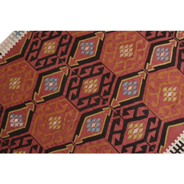 Handwoven in a wool flat-weave originating from Turkey, circa 1950-1960, this vintage Kilim rug connotes a mid-century...