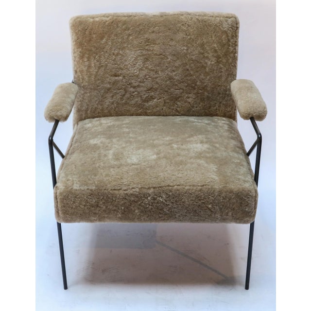 Custom black metal armchair with tan sheepskin upholstery. Seat depth: 21".