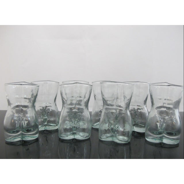 Quirky, vintage clear glass shot glass set of 8 featuring a playful human male torso shape with distinct anatomical lower-...