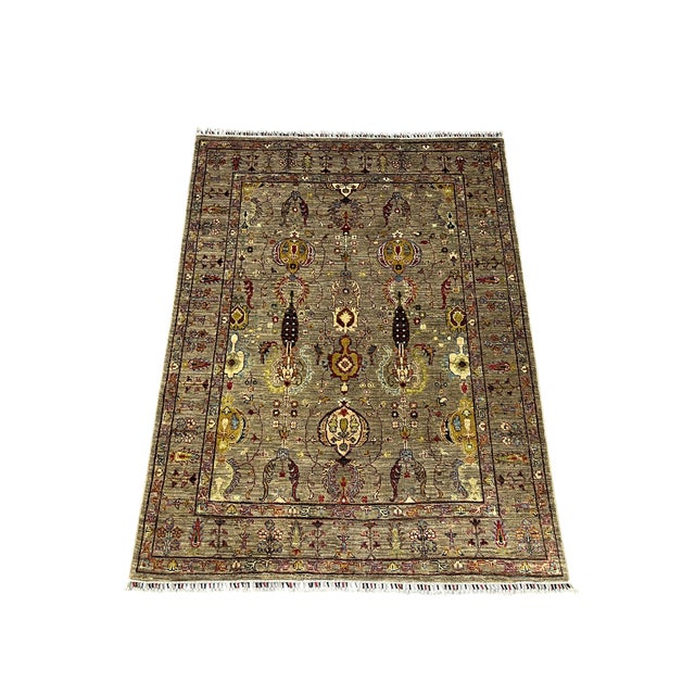 This Sultani wool rug features a pineapple and floral design on a warm gray field. Burgundy, gold, cream and muted blue...