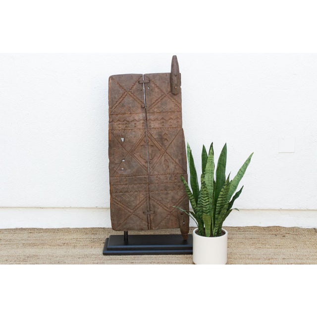 From the Bandiagara escarpment region of Mali, this two-plank granary or shrine door is carved with stacked bands of...