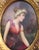 Gilt wood frame with porcelain portrait. A fine Pre-Raphaelite maiden in a sheer dress with a garland of roses around the...