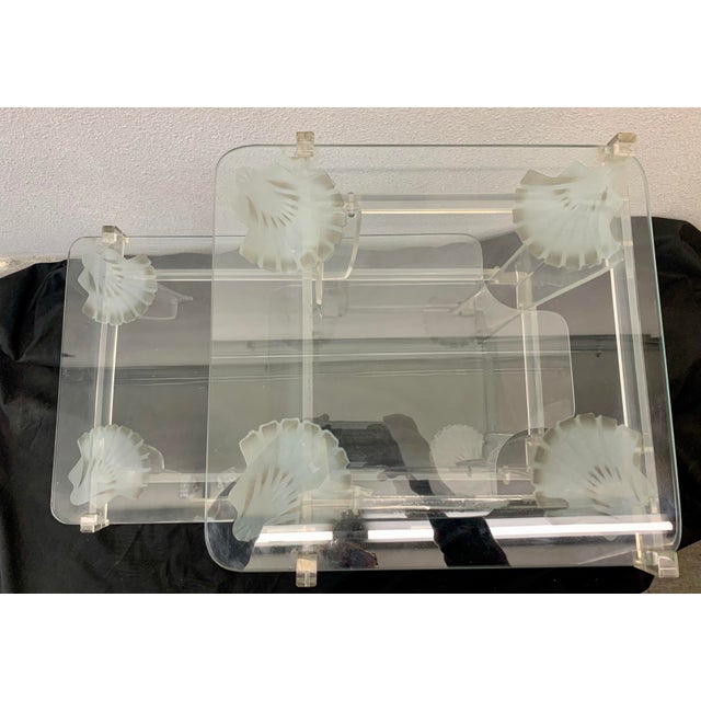 This elegant 1970s/80s accent table features a clear, thick glass top supported by a sculptural Lucite base. The piece is...