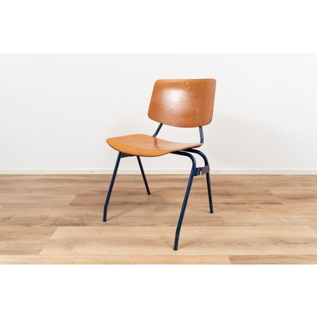 Industrial chairs by Kho Liang Ie for CAR Katwijk. The chair comes with a wooden seating and backpiece on a blue coated...