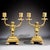 Charming pair of French gilt bronze two-light candelabra, dating to the late 19th century (circa 1885–1900). Each piece...