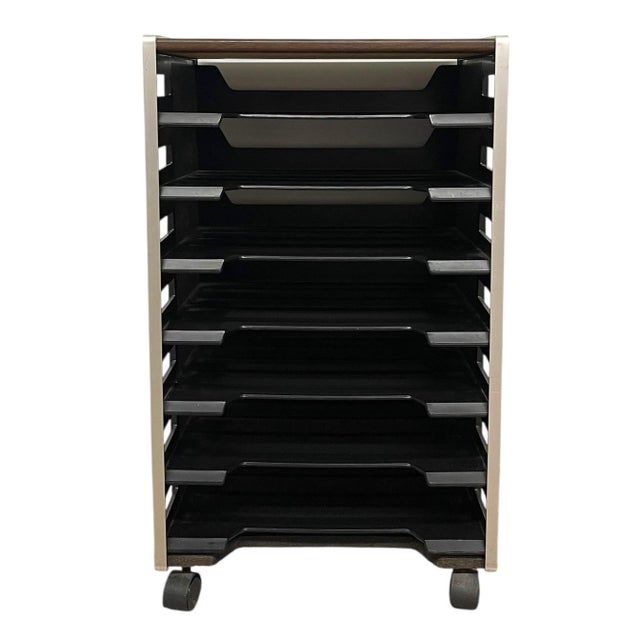 This vintage rolling office organizer features a vertical, open-sided design with multiple tiered plastic trays arranged...